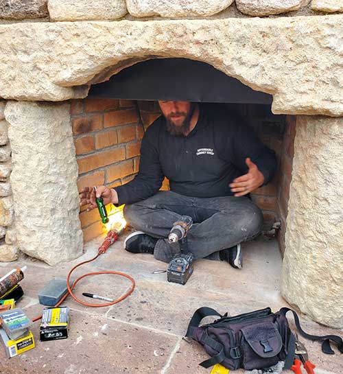 Tucson Chimney - Technician inside Adobe looking Fireplace